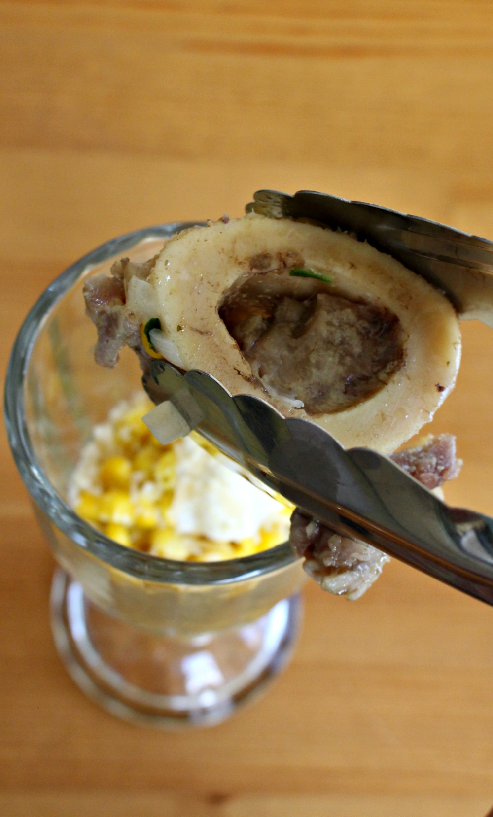 Tongs holding Bone Marrow Rumba Meats