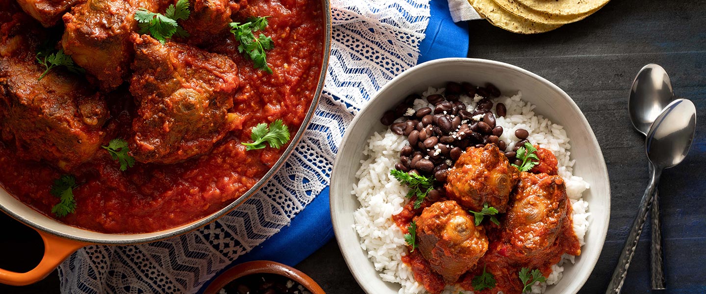 plated oxtail stew with beans and rice